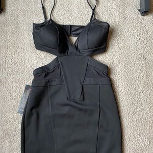 Bebe dress with deep V neck and mesh inserts.